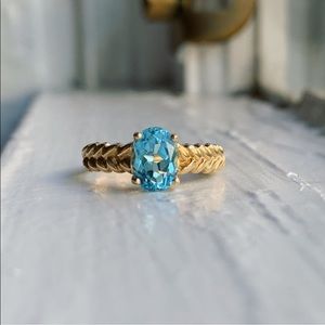 10k ring with blue topaz and braided sides